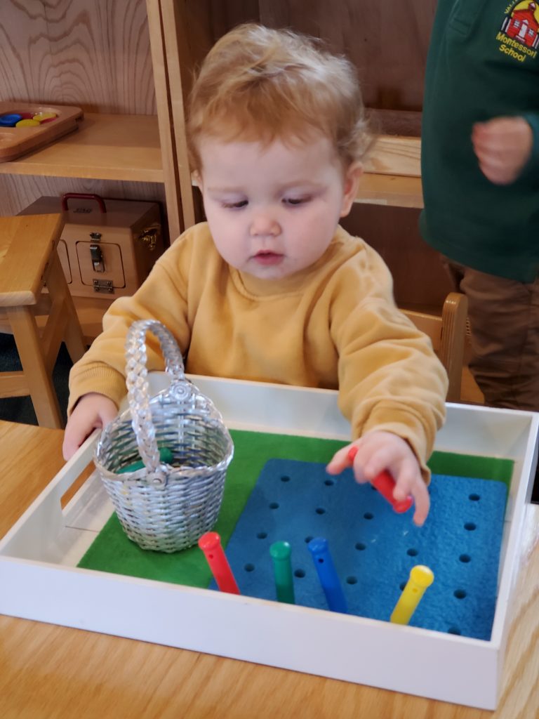 Child Placing Pegs in Peg Board