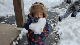 Child Outside Playing in Snow