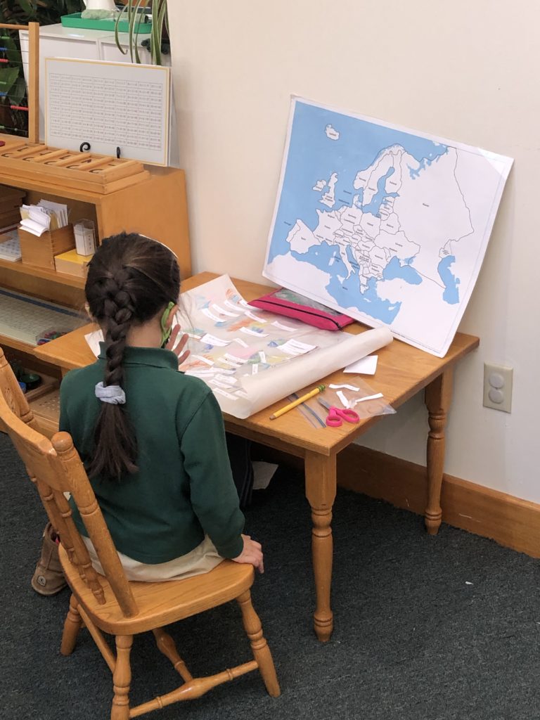 Child at Desk with Map