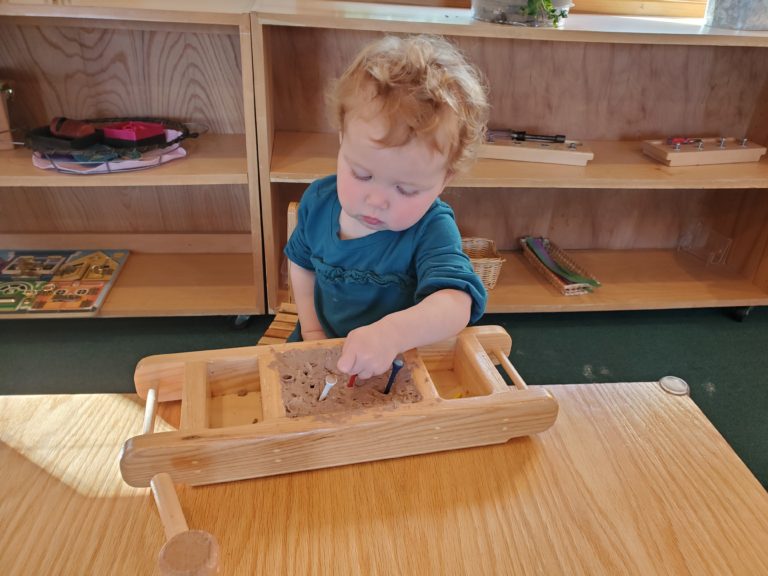 Child Placing Tees in Clay