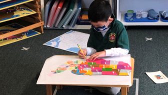 Child in Classroom with map