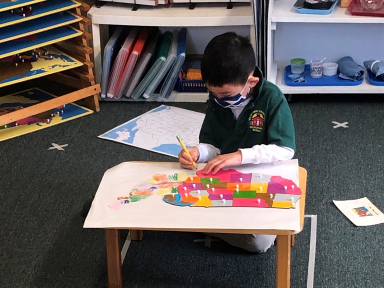 Child in Classroom with map