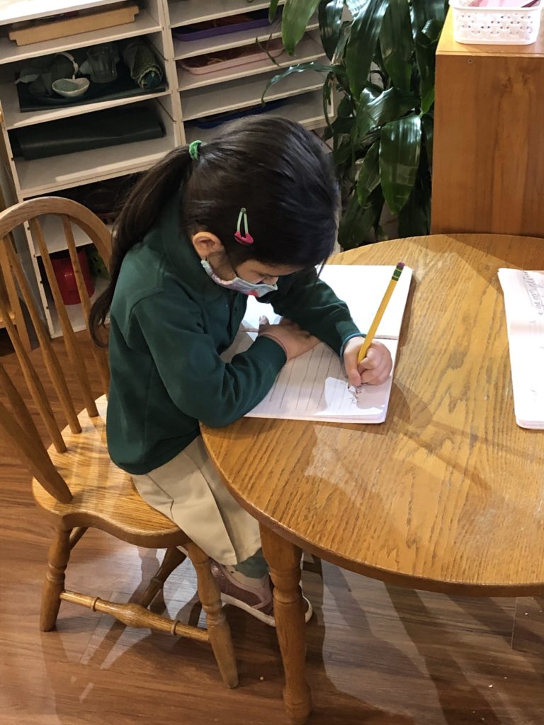 Child practices writing letters