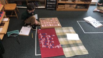 Child using moveable alphabet