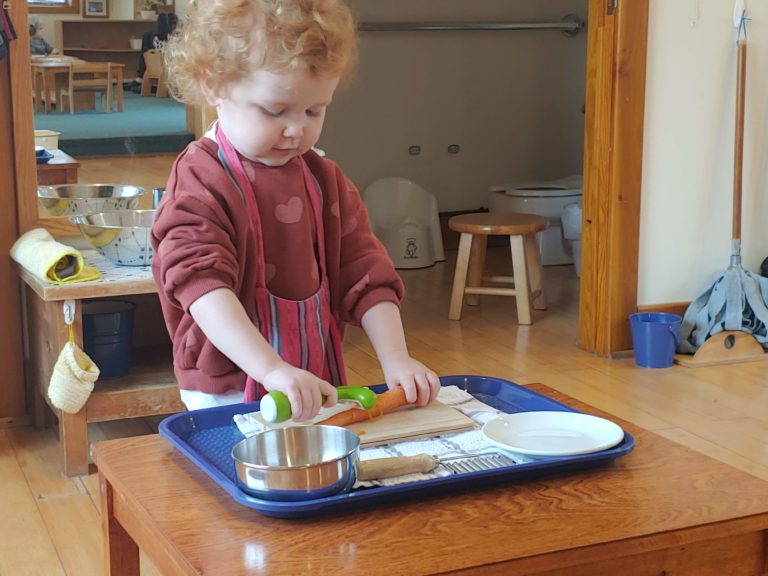 Child Peeling Carrot for Snack