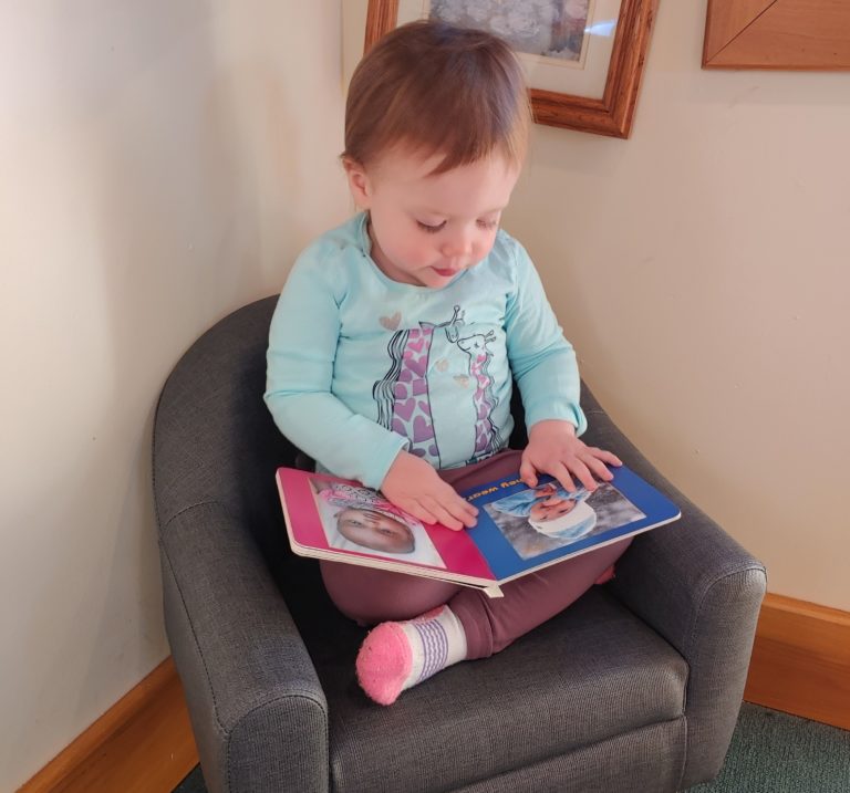 Toddler reading a book